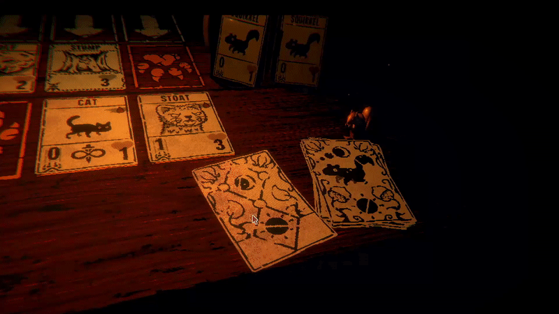 In dark cabin a rustic card game is set up on a wooden table, seen from first-person perspective. The player attacks with two cards marked 'wolf' and 'stoat', causing teeth to be loaded on the opponent's end of a scale. The opponent attacks with their own wolf in kind, and the scale swings back toward the player.