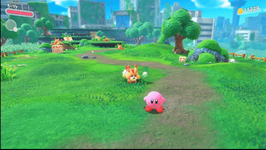 The round pink creature Kirby dodges a charging fox in an open grassy field, as time slows to a crawl. Time resumes as kirby goes in to inhale and swallow the fox whole.