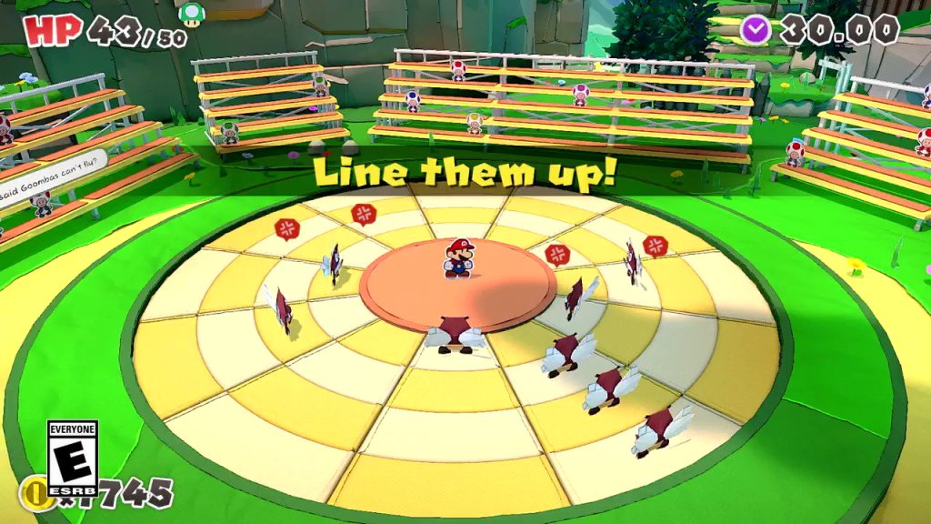 Mario stands on the center of a series of concentric circles, surrounded by origami goombas with wings. A text pop up at center-screen reads "Line them up!"